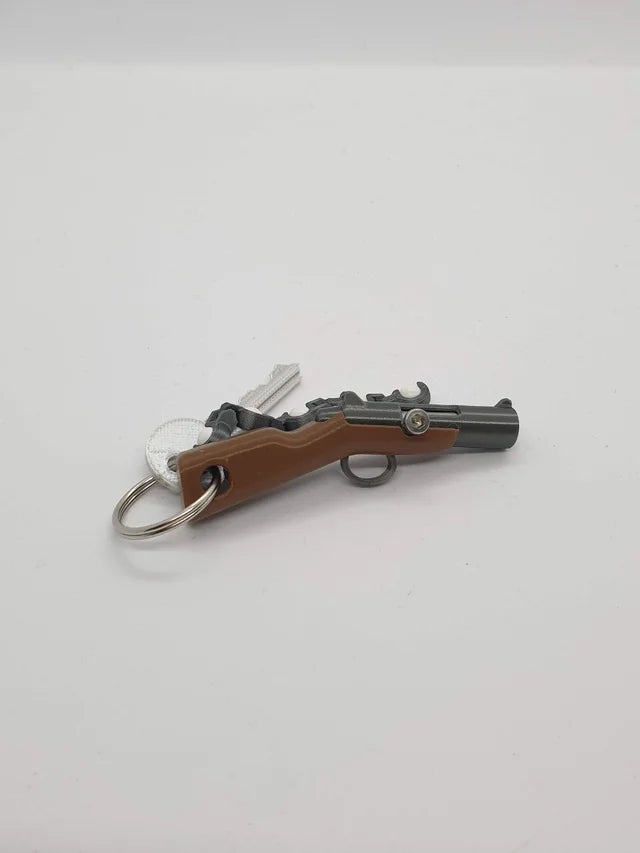 Mini Llavero Pistola de Muelle Funcional - Dispara Bolas de Plástico